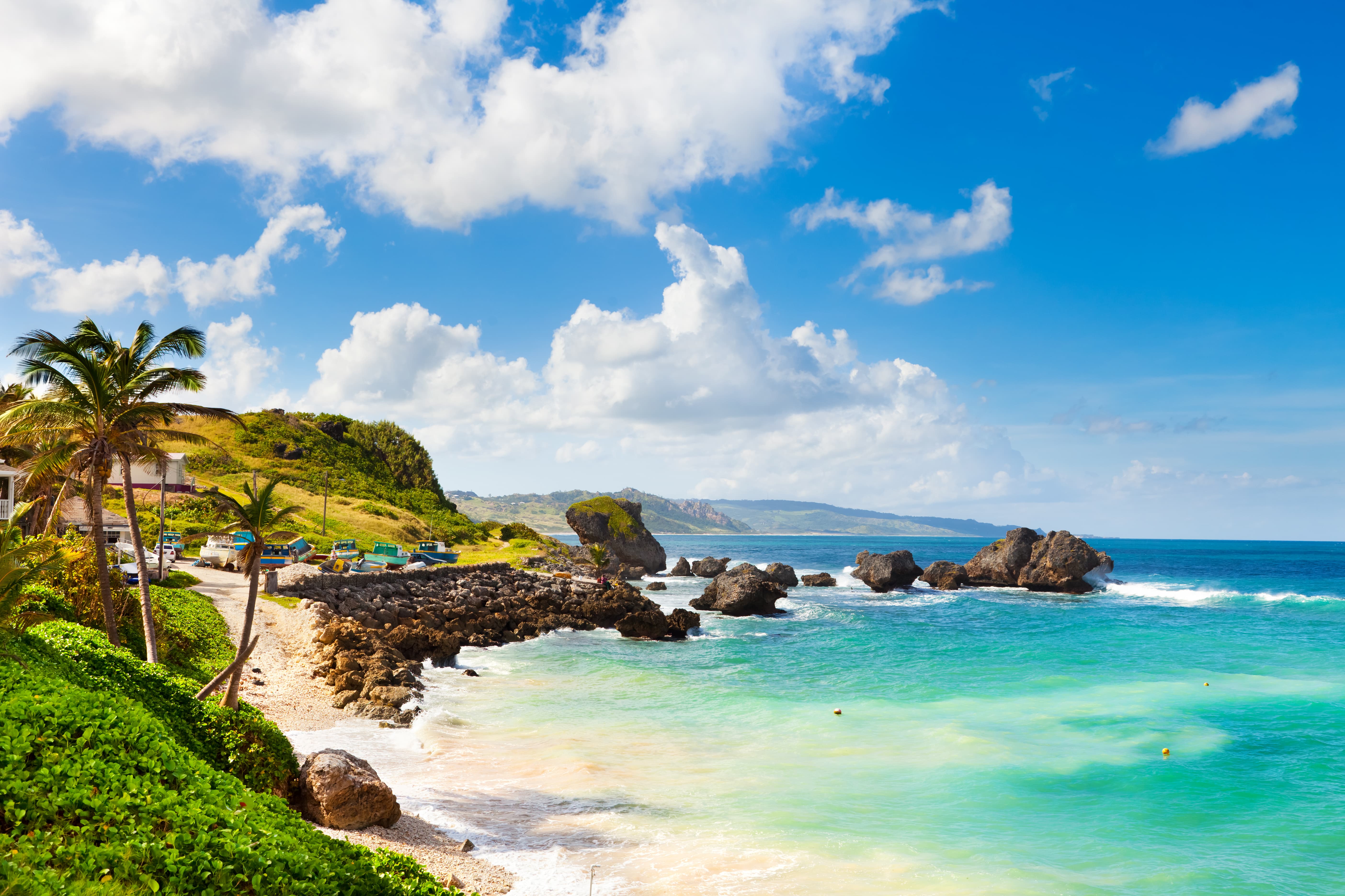 Grenada coastline with boulders and hilly backdrop