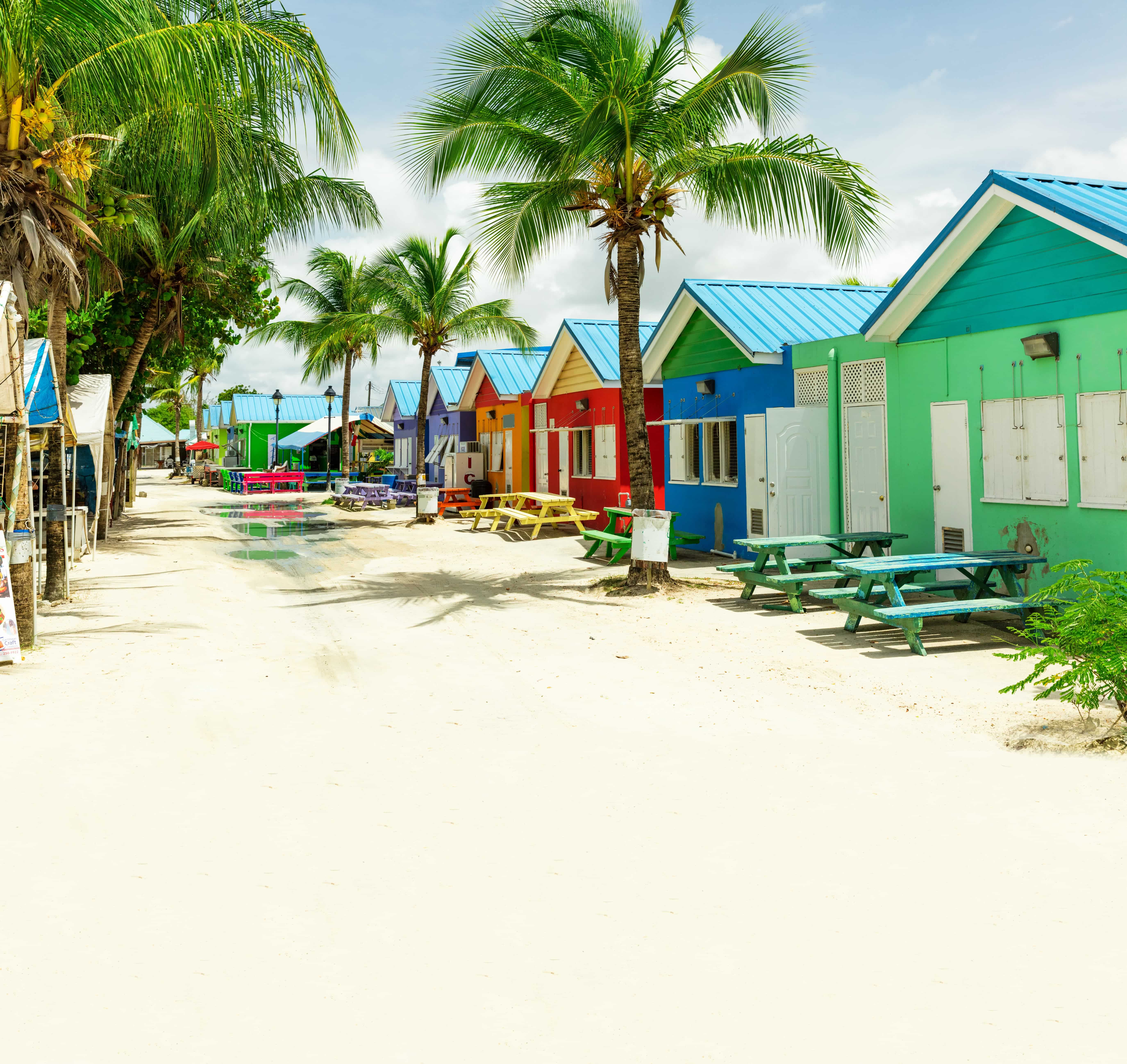 Pastel-coloured buildings on Barbados with palm trees